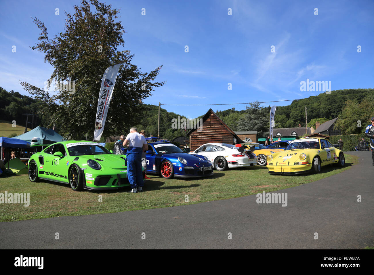 Racing Porsche 911`s in a sunny paddock at Shelsley Walsh hillclimb, Worcestershire, England, UK. Stock Photo